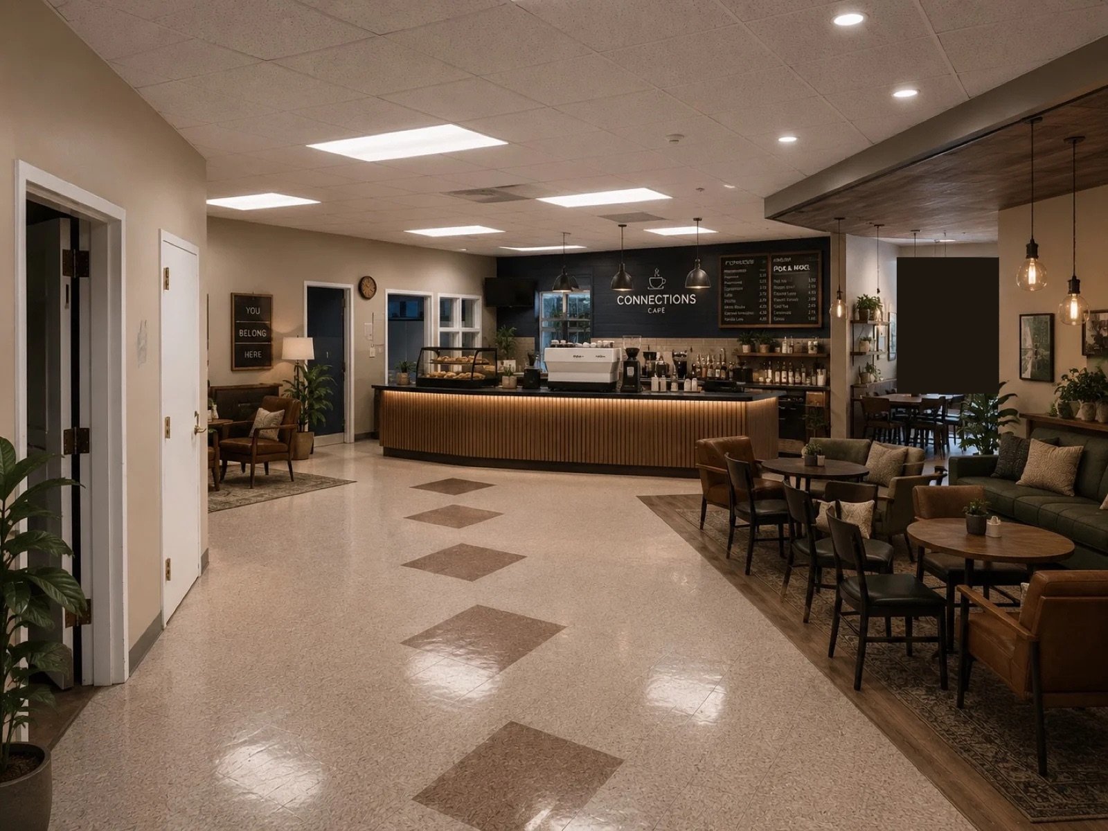 Concept rendering of the Connection Cafe: a coffee bar with seating areas, warm lighting, and a "You Belong Here" sign near the entrance